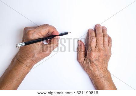 Senior Woman's Left Hand With Pencil Writing On White Paper