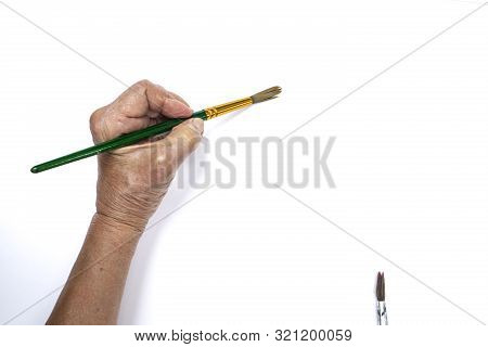 Senior Woman's Hand Painting With Paintbrush Isolated On White Background