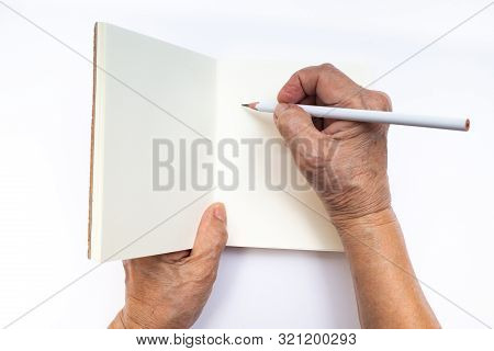 Senior Woman's Right Hand With White Pencil Writing On Notebook Isolated On White Background, Statio