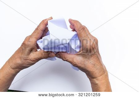 Senior Woman's Hand Crumpling White Paper Isolated On White Background, Angry Mood