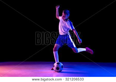 Young Boy As A Soccer Or Football Player In Sportwear Making A Feint Or A Kick With The Ball For A G