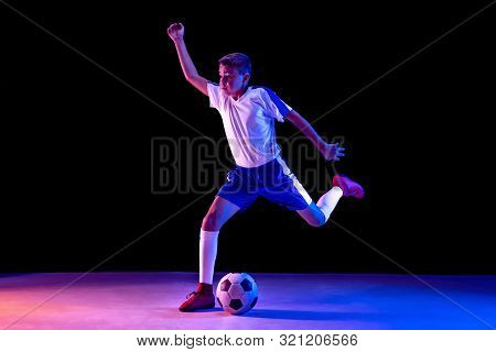 Young Boy As A Soccer Or Football Player In Sportwear Making A Feint Or A Kick With The Ball For A G