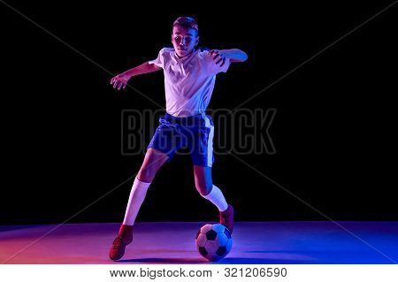 Young Boy As A Soccer Or Football Player In Sportwear Making A Feint Or A Kick With The Ball For A G