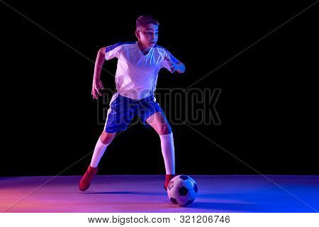 Young Boy As A Soccer Or Football Player In Sportwear Making A Feint Or A Kick With The Ball For A G