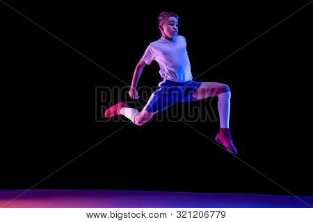 Young Boy As A Soccer Or Football Player In Sportwear Making A Feint Or A Kick With The Ball For A G