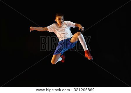 Young Boy As A Soccer Or Football Player In Sportwear Making A Feint Or A Kick With The Ball For A G