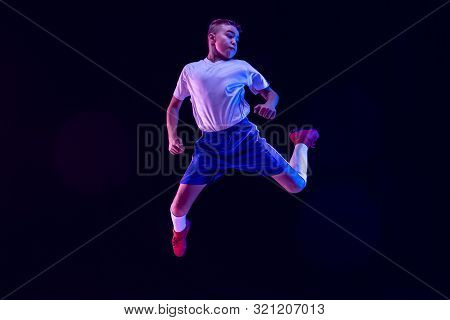 Young Boy As A Soccer Or Football Player In Sportwear Making A Feint Or A Kick With The Ball For A G