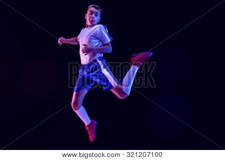 Young Boy As A Soccer Or Football Player In Sportwear Making A Feint Or A Kick With The Ball For A G