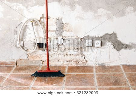 Unfinished Room Reconstruction. Home Repair, Improvement. Work In Progress. Red Broom Against White 