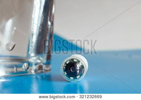 Capsule With Camera For Capsular Endoscopy And Glass Of Water