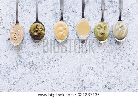 Nuts And Seeds Butter On A Spoons. Homemade Raw Organic Almond, Hazlenut, Cashew, Pistachio, Macadam
