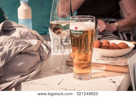 Ameland, The Netherlands, 08/31/2019, Toast! Cold Beer, Glass Of White Wine, Bitterballen  On The Ta