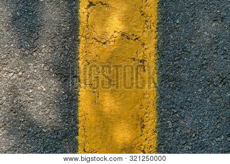 Asphalt Texture With A Yellow Dividing Strip. Top View