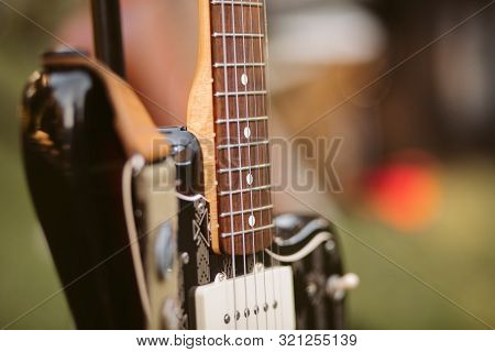 Close Up Of Electric Guitar. Detail Of The Strings.  Electric Guitar On A Stand Before A Concert. Gu