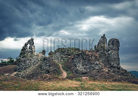 The Ruins Of An Old Castle In Khust, Transcarpathia Ukraine, Against A Background Of Thunderclouds.