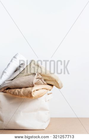 Clean Clothes In The Basket Of Laundry. Space For Text. Bioorganic Product Layout.