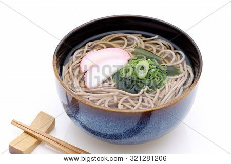 Japanese Kake Soba Noodles In A Ceramic Bowl On White Background