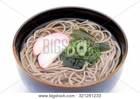 Japanese Kake Soba Noodles In A Ceramic Bowl On White Background