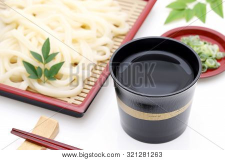 Japanese Chilled Zaru Udon Noodles In A Plate With Mentuyu On White Background