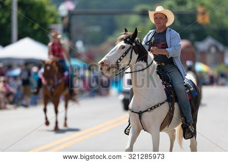 Buckhannon, West Virginia, Usa - May 18, 2019: Strawberry Festival, Caucasian Man Riding A White Hor