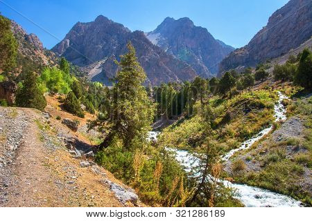 Scenic Mountain Landscape With River On Clear Summer Day. Beautiful Bright Mountains. Hiking In Moun
