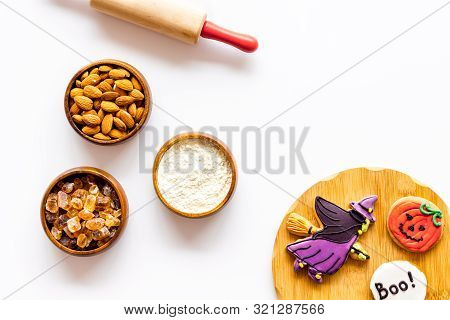 Cooking Halloween Cookies In Shape Of Spooky Figures, Rollin Pin, Nuts And Flour On White Background