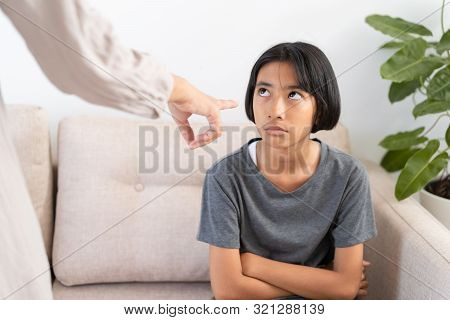 Asian Mother Is Angry And Scold Her Daughter While Sitting On The Sofa Because Of Bad Behavior. The 