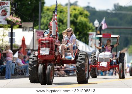 Buckhannon, West Virginia, Usa - May 18, 2019: Strawberry Festival, Old Tractors Being Driven Along 