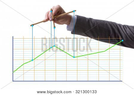 Businessman controlling the market with strings