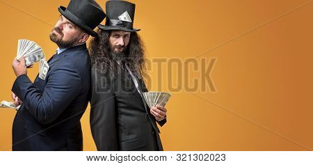 Two gentelmen holding dolars in their hands