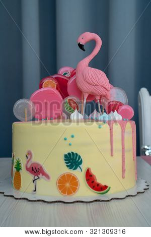 Flamingo Cake At The Hawaiian Party. Childrens Birthday Cake Aon The Table. Vertical Photo.