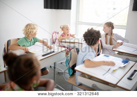 Pupils Talking To Each Other While Having Little Break