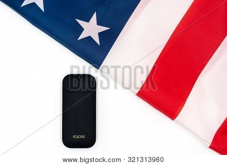 Black Iqos Box, Americas Flag On White Background. Iqos Electronic Cigarette Ban Concept In The Usa.