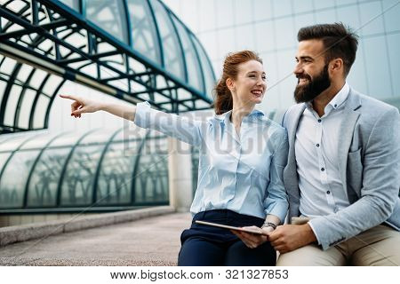 Business People Talking, Smiling And Discussing Ideas Outside.