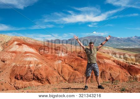 Happy man in Valley of Mars landscapes in the Altai Mountains, Kyzyl Chin, Siberia, Russia