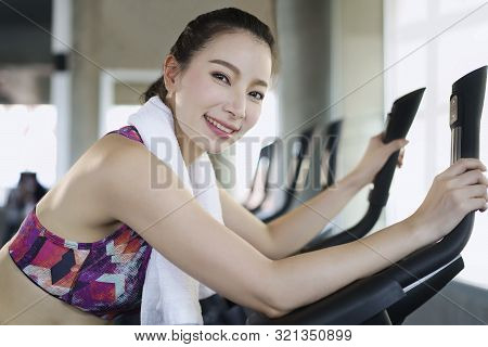 Asian Woman Sporty Doing Excersice Bike Indoor At Fitness Gym. Healthy Sport Cardio Strong.