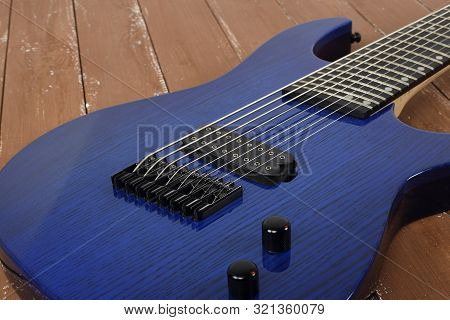 Musical Instrument - Fragment 8-string Blue Electric Guitar Solid-body On A Wood Background
