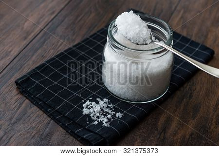 Maldon Sea Salt Flakes In Jar With Spoon.