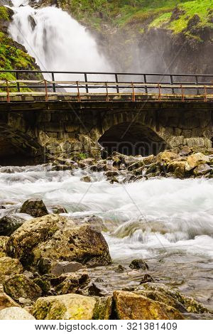 Norwegian Landscape. Waterfall Latefoss Latefossen With Stone Arched Bridge Road, Odda Hordaland Nor
