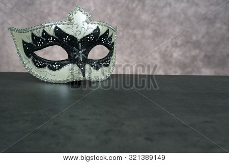 Photo Of Elegant White And Black Venetian, Carnaval Mask Over Dark Background. Vintage Photo
