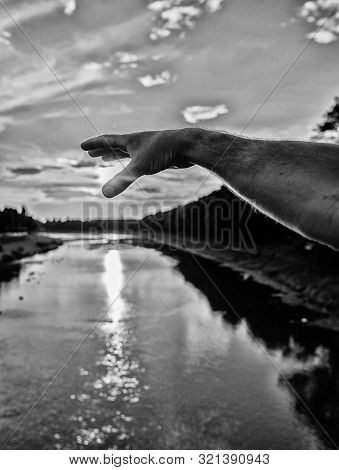 River Sun Reflection. Catch Last Sunbeam. Male Hand Pointing At Sun In Blue Sky At Evening Time Admi