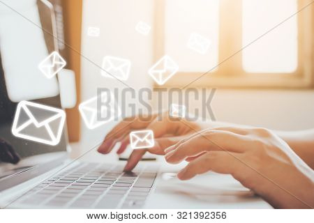 Email Marketing And Newsletter Concept. Hand Of Man Sending Message And Laptop With E-mail Icon