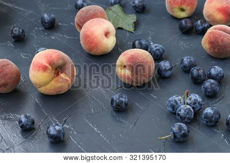 Peaches And Berry Blackthorn Are Located On A Dark Background In Random Order, Horizontal Orientatio