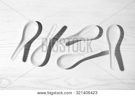 Flat Lay Composition With Miso Soup Spoons On White Wooden Table