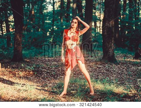 Desire. Wild Woman In Forest. Sexy Girl In Leather Clothes. Deep Forest. Cougar Female. Amazon Woman