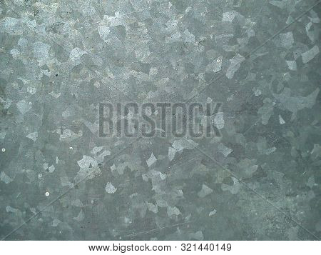Close-up Of A Piece Of Chrome-plated Gray Aluminum With Bright Patches That Glitters Beautifully In 
