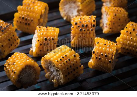 Sweet corn slices grilled and spiced as healthy party food alternative