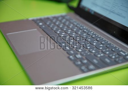 Modern Laptop Computer On Green Background. The Concept Of Work In The Office.metal Laptop Keyboard 