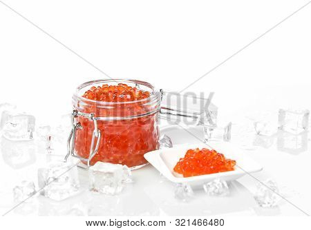 Salmon Or Keta Red Caviar In Jar Can And Little Plate With Ice On Table. Sea Food. Healthy Eating
