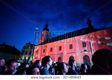 SIBIU, ROMANIA - JULY 26, 2019: Crowd of people headbanging and partying during rock concert at Artmania Festival